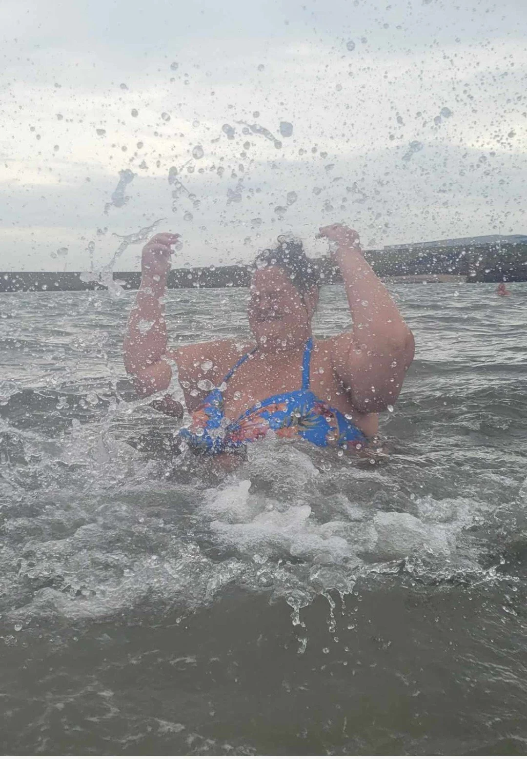 Kathleen splashing water in the sea.