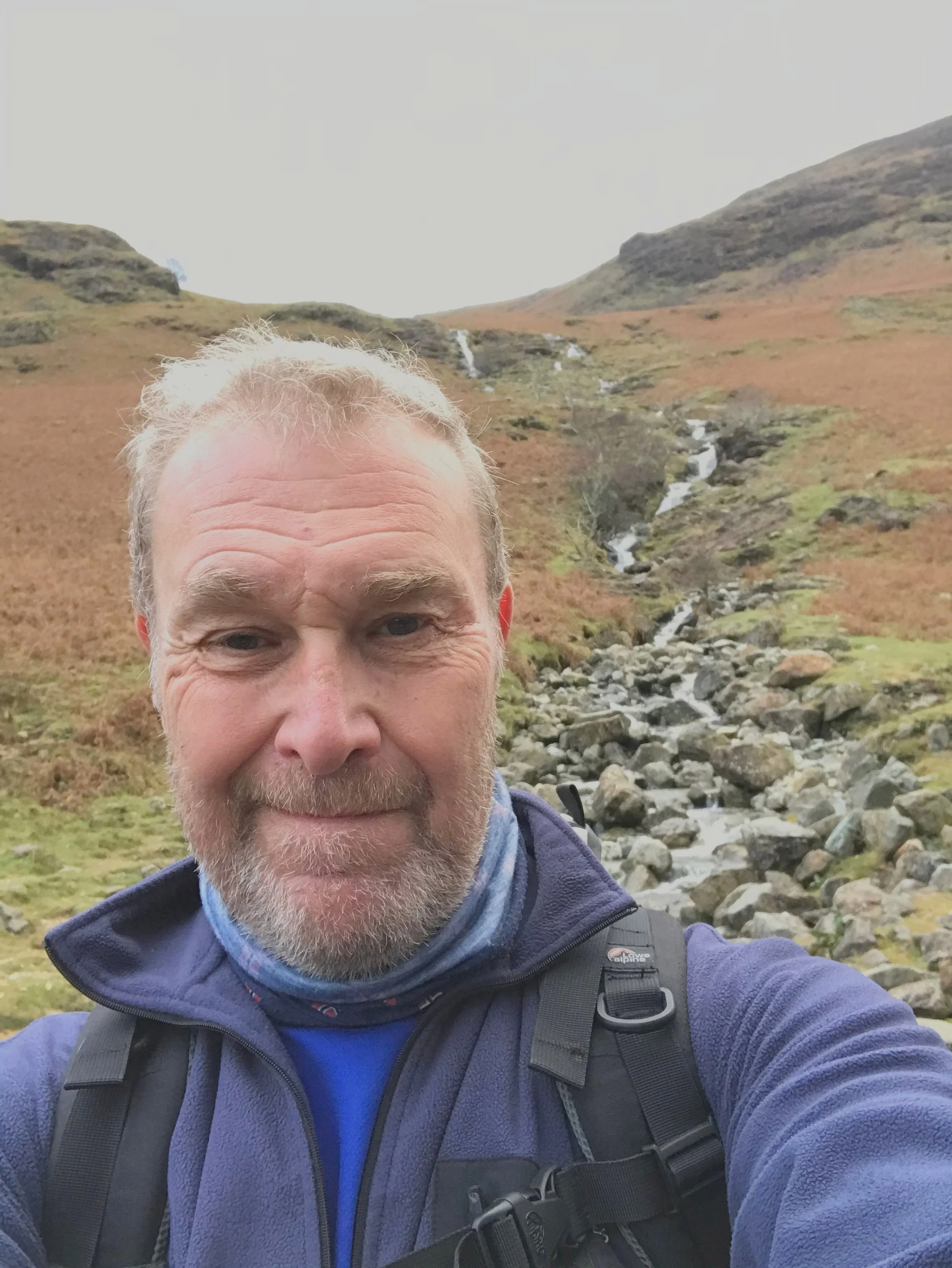 An image of lived experience participant Ivor smiling in the countryside.