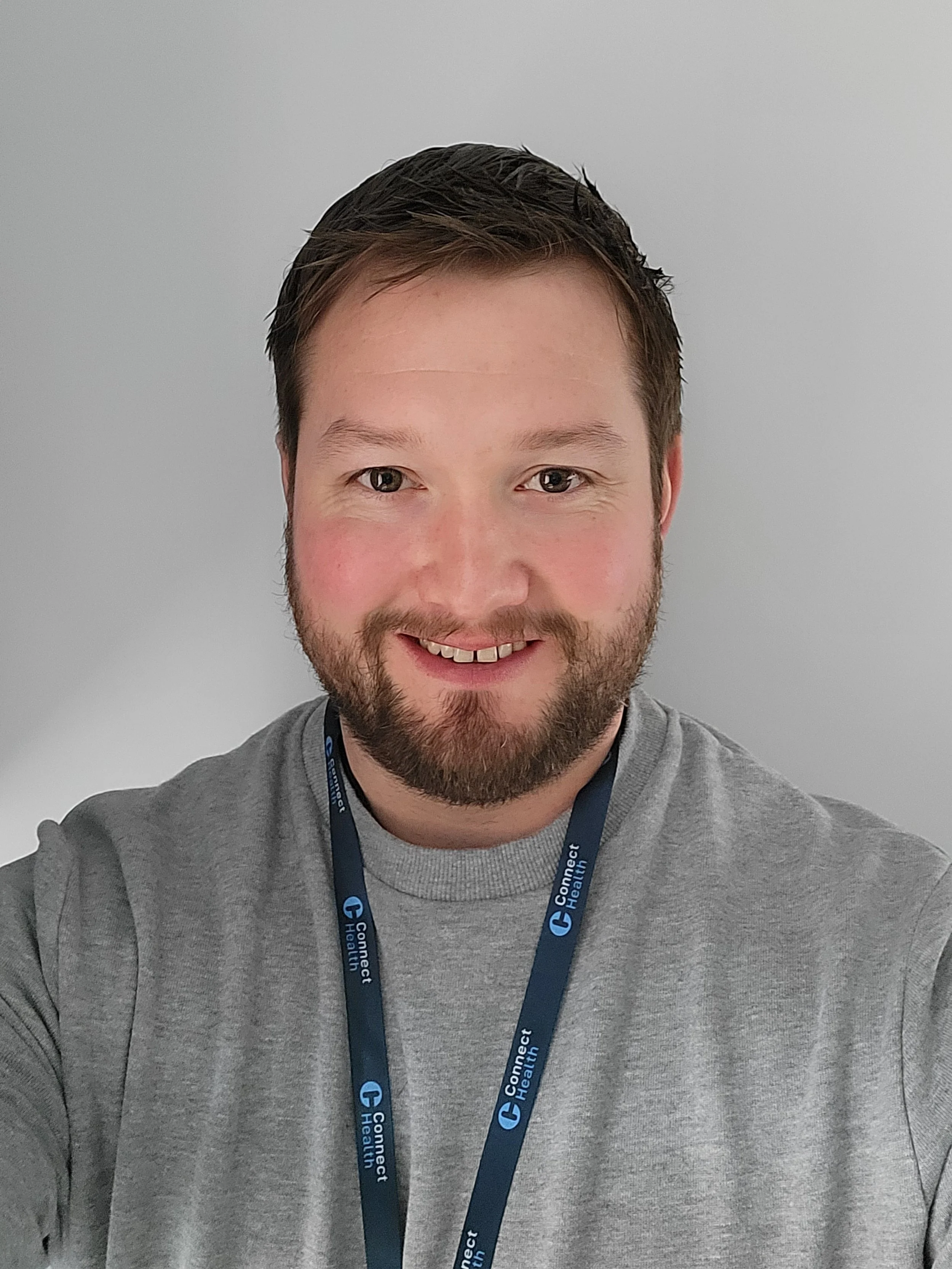 Kevin smiling at the camera.