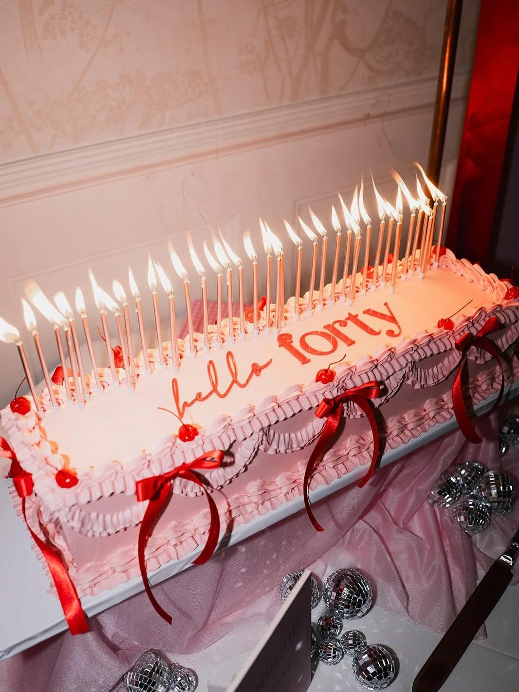 hello FORTY

This was definitely a go big or go home moment for the cake. Pink &amp; red vibe for @rachy_166 40th birthday party. A long style vintage style cake with bows and cherries&hellip;oh and 40 (yes 40!!) candles! 

A shout out to the great t