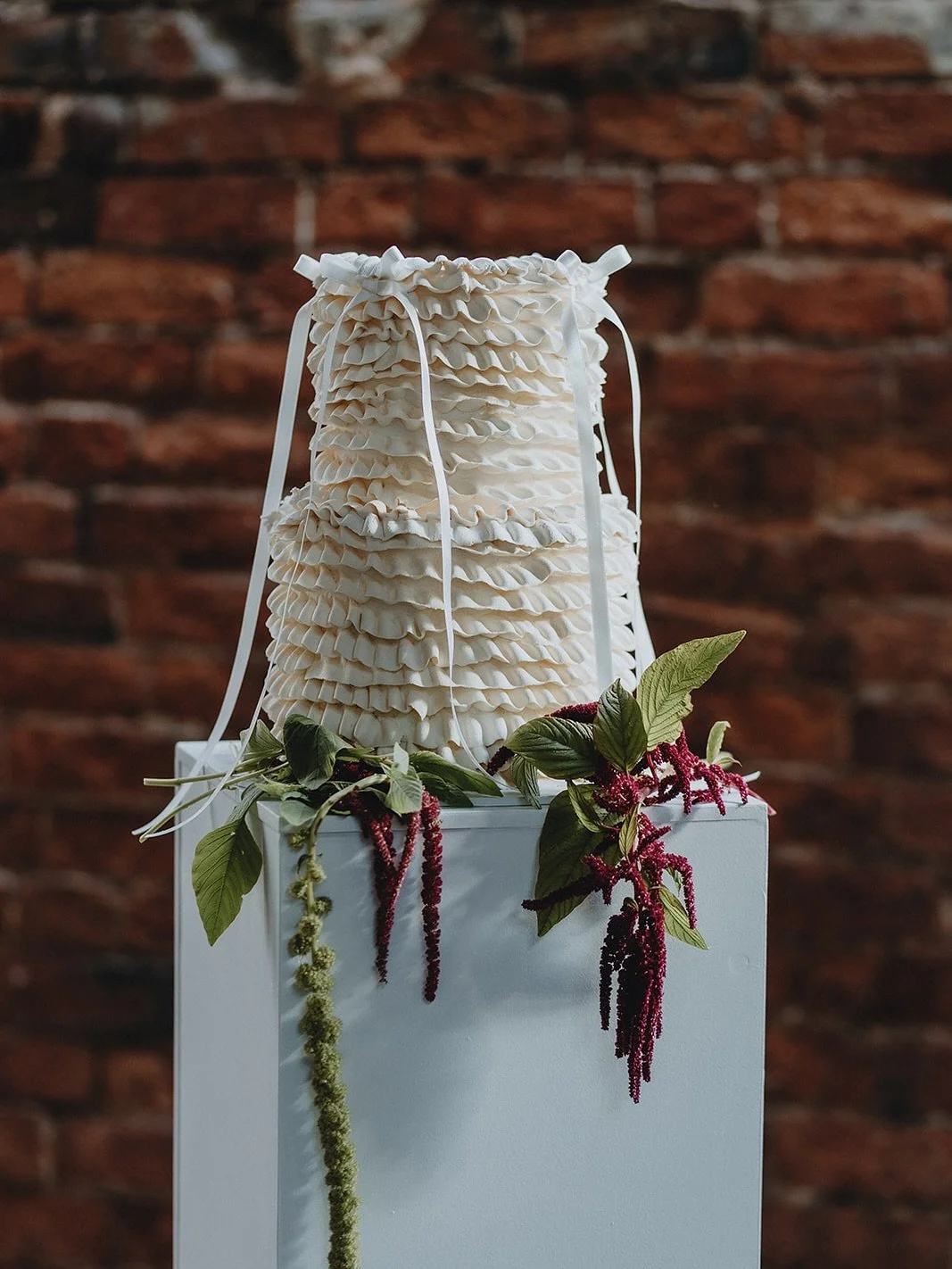 Layers and layers of buttercream ruffles with long ribbon bows.

A beautiful burgundy photoshoot day with a super creative team.

Wedding Planner &amp; Designer @theaisleplanner
Florist @sweetpea_florals__ 
Content creator @PMSOCIALS
Cake @thegingerb