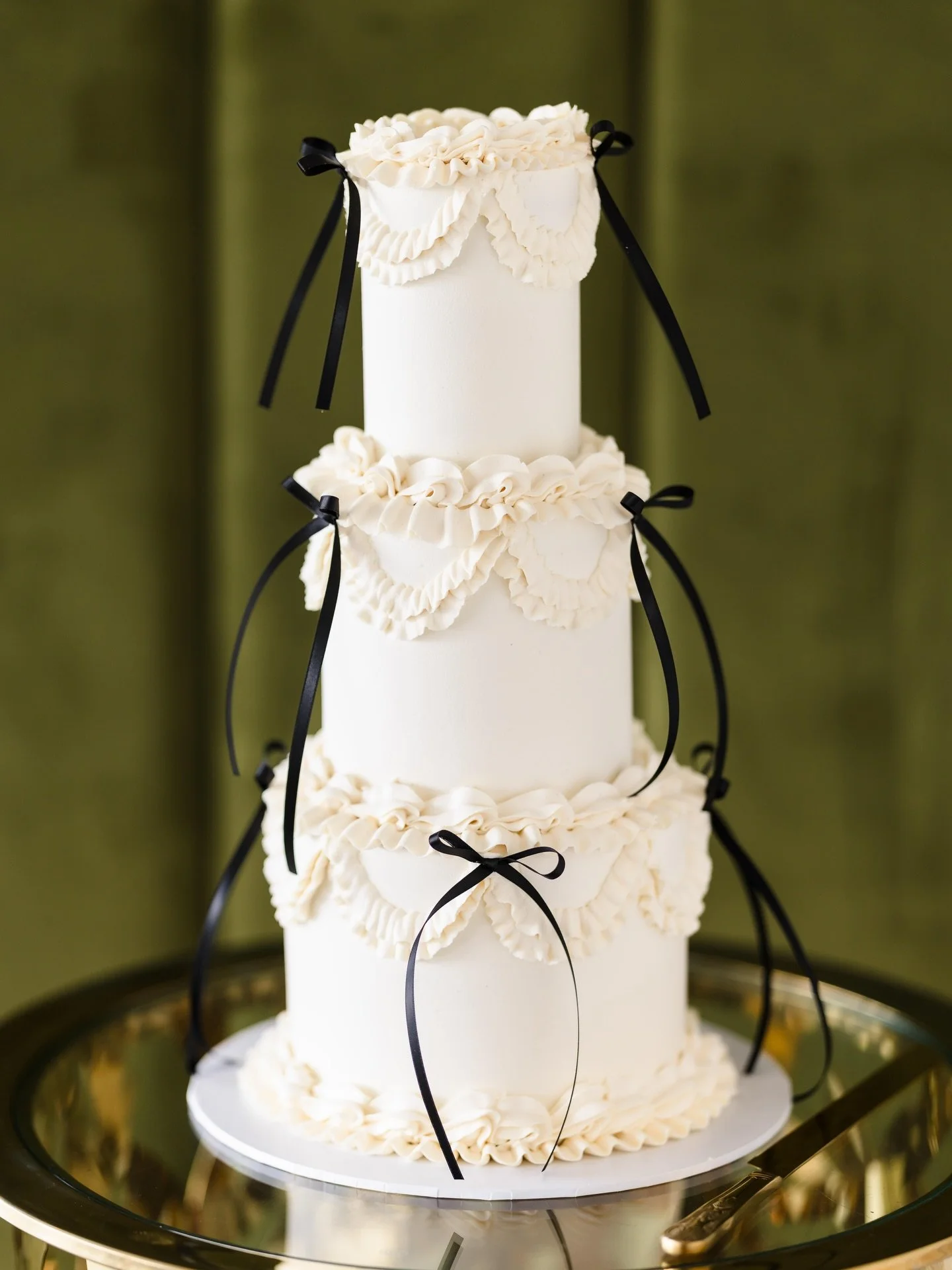 I can confirm that the vintage vibe is still going strong into 2026, whether it be with bows, cherries, quirky wording (or all three!) it definitely isn&rsquo;t going anywhere. 

Rhian &amp; Sion chose a three tier, vintage piped buttercream cake wit