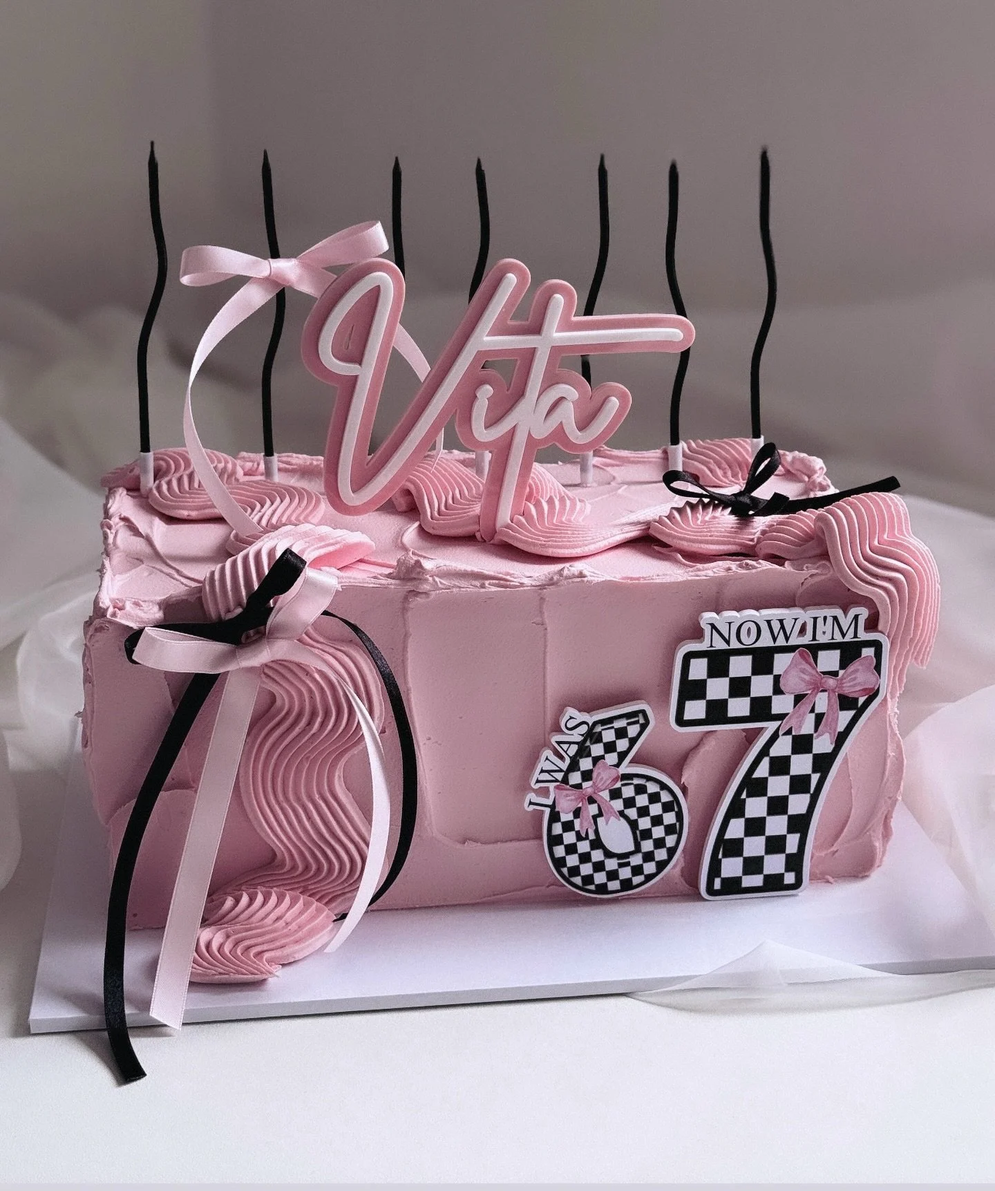 The &ldquo;6 7&rdquo; trend is making its way into cakes. A pink rectangle cake for Vita&rsquo;s 7th birthday&hellip;featuring seven wiggly candles! 

Acrylic toppers and printed charms @burntisland_occasions 

#67 #sixseven #birthdaycake #kidscake #