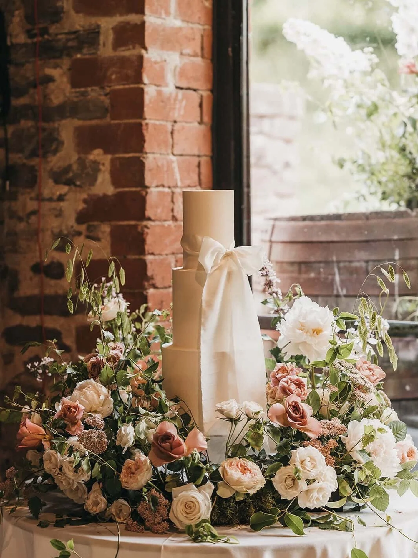 When bows and flowers are everything. A three tier cake, placed in a beautiful meadow of fresh florals with the added detail of a silk ribbon bow.  The cake made into a perfect part of your decor.

Photo @hannahmaymiles 
Flowers @the_foxglove_diaries