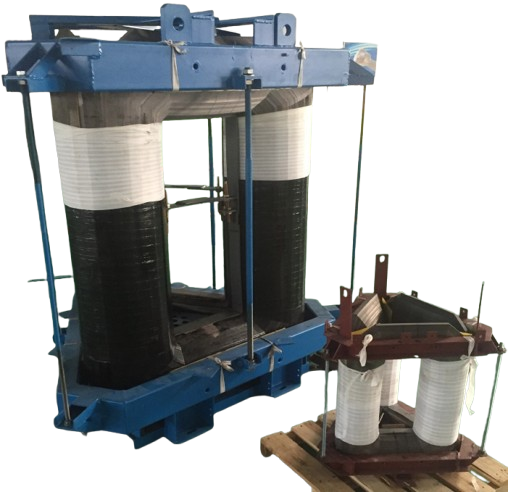 Large industrial transformer coils mounted on blue metal frame with smaller transformer coils on wooden pallet.