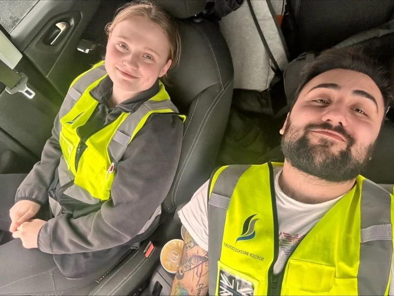 The company team in a car at work
