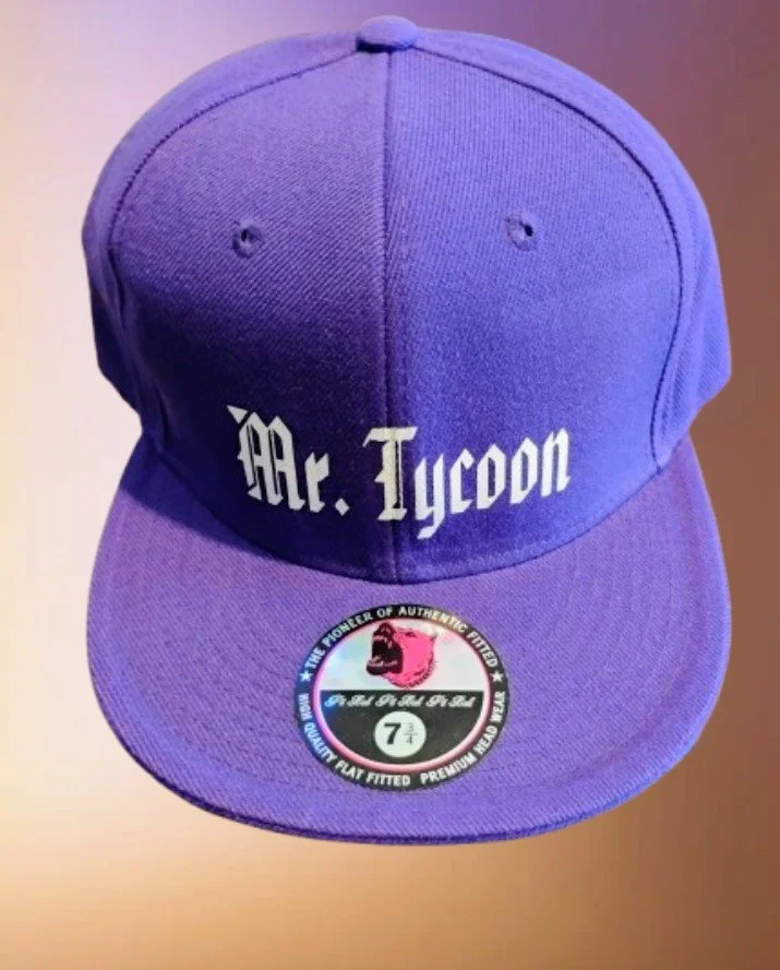 Purple baseball cap with the text "Mr. Tycoon" embroidered on the front. A sticker on the brim indicates it is a 7 1/4 size fitted cap from the