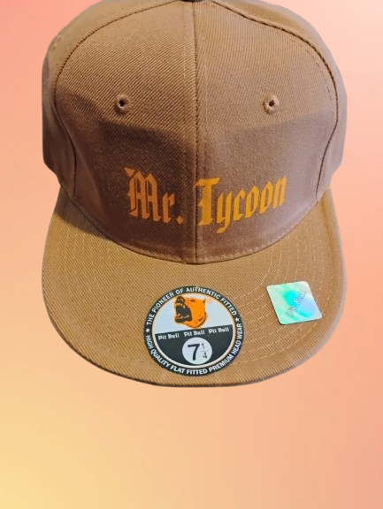 A tan baseball cap with the words "Mr. Tycoon" embroidered on the front in yellow and orange thread.