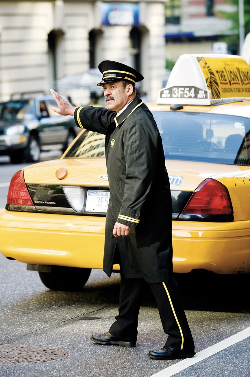 Doorman James Fitzgerald hails a cab for a resident