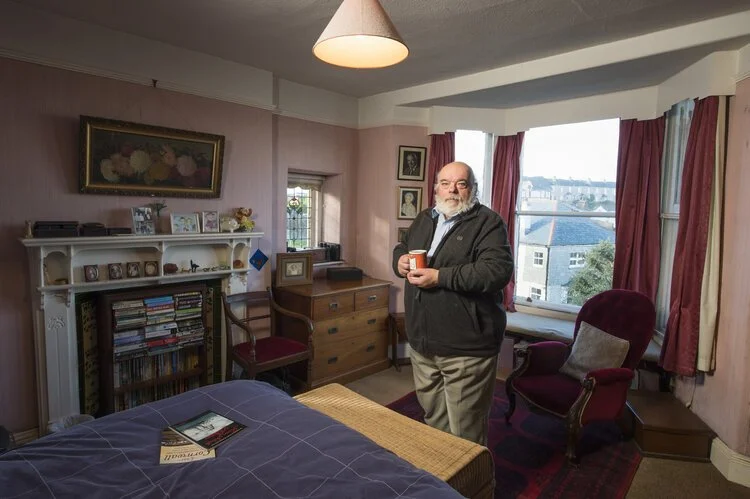 David Hill in his house in Polruan, Cornwall. His grandfather built the house and three generations of the family have slept in this room.