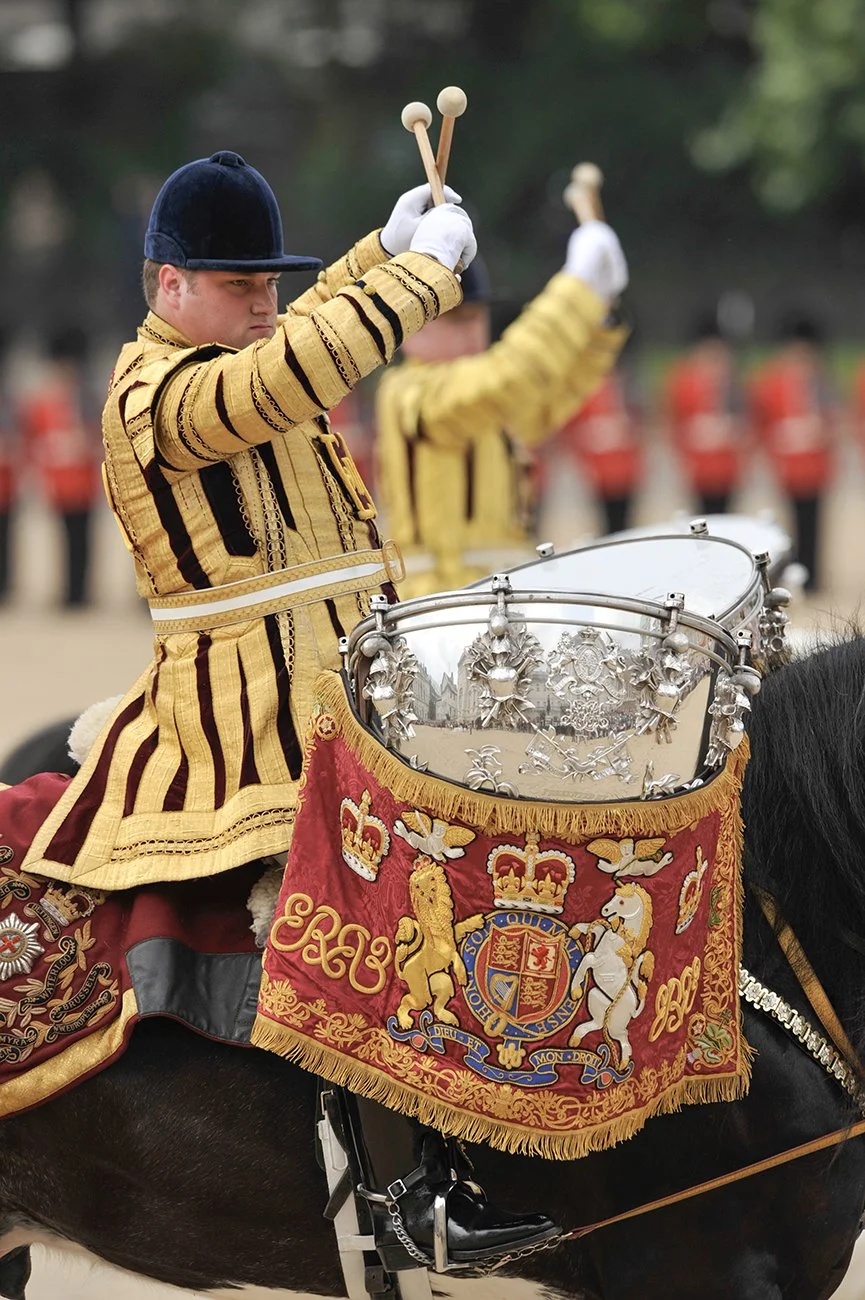 The kettle drummers give the crossed sticks salute as they leave the parade