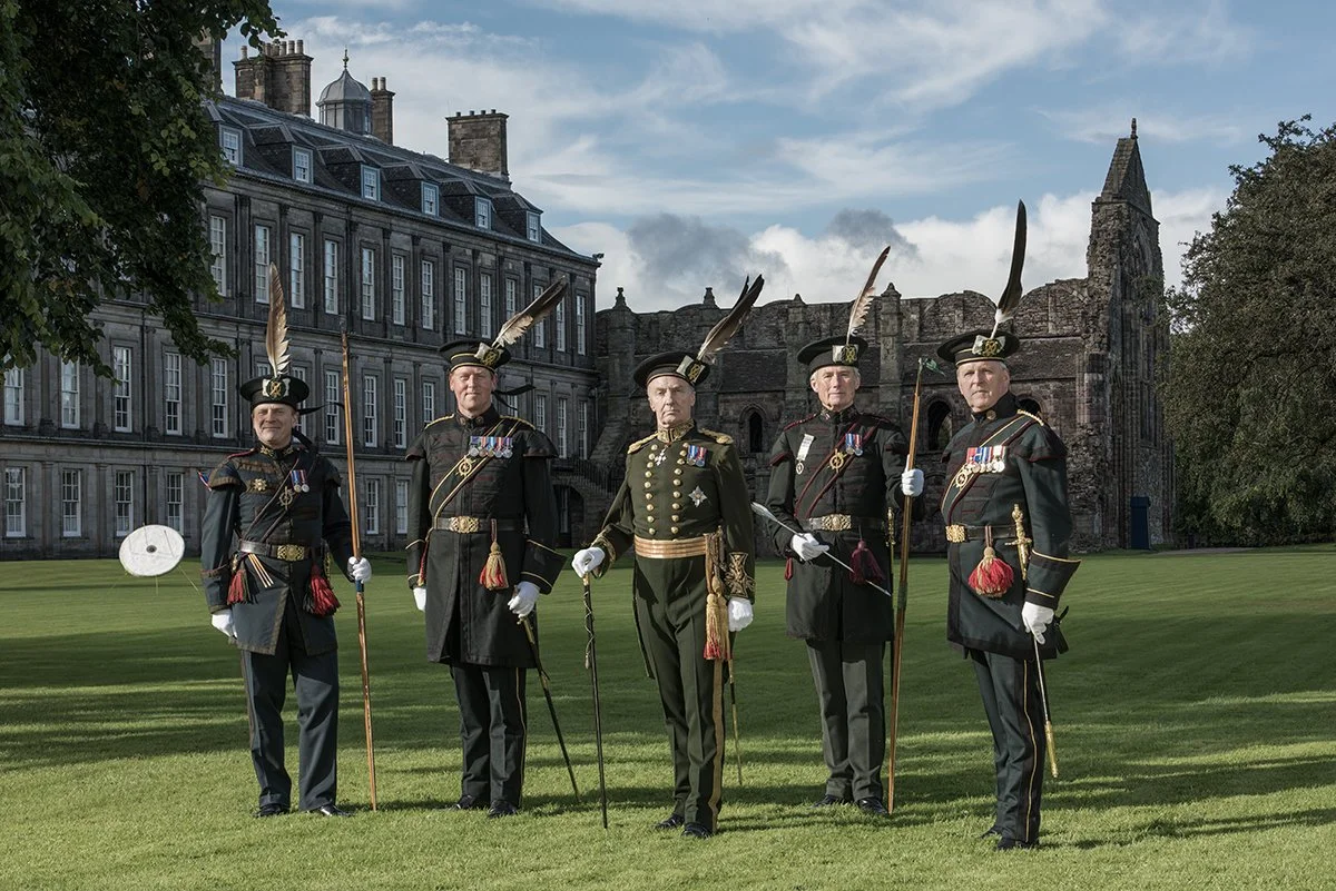 The Queen's Bodyguard for Scotland in front of Holyrood House. The archer second on the right holds the Musselborough Arrow, one of the oldest sporting trophies in Britain