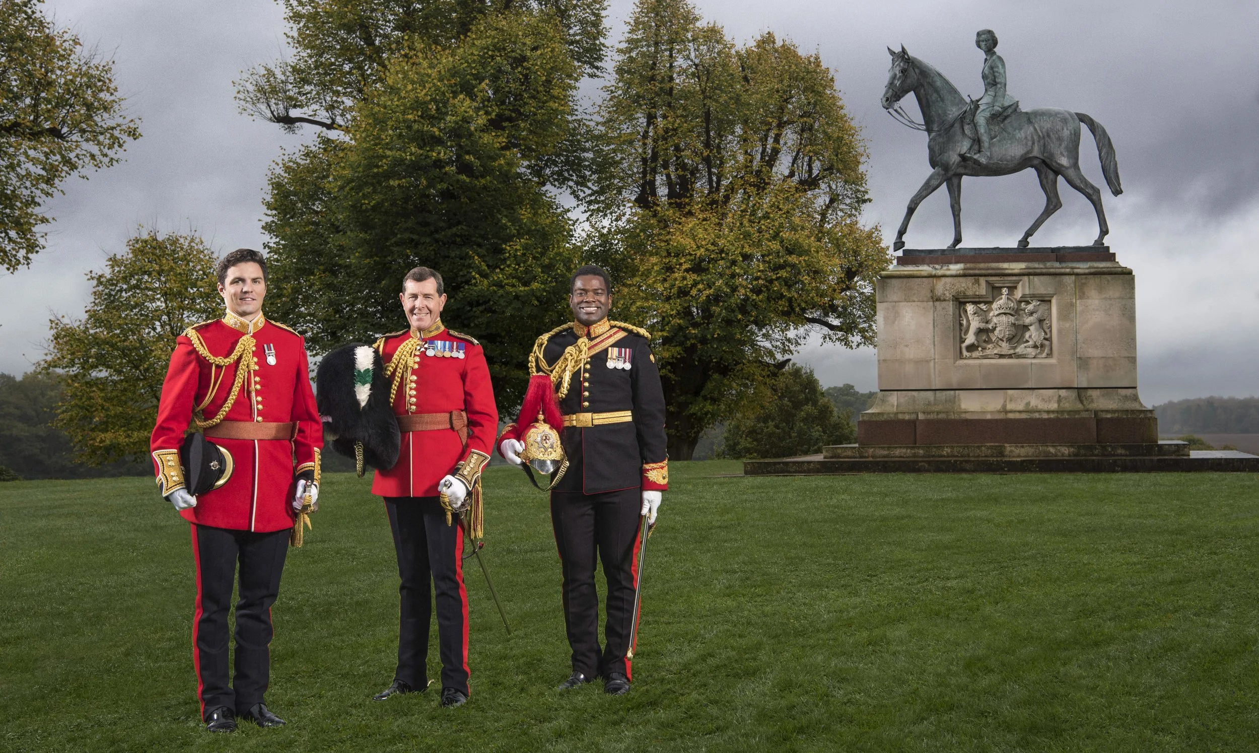 The Queen's Equerries in front of H.M the Queen's statue in Windsor Great Park