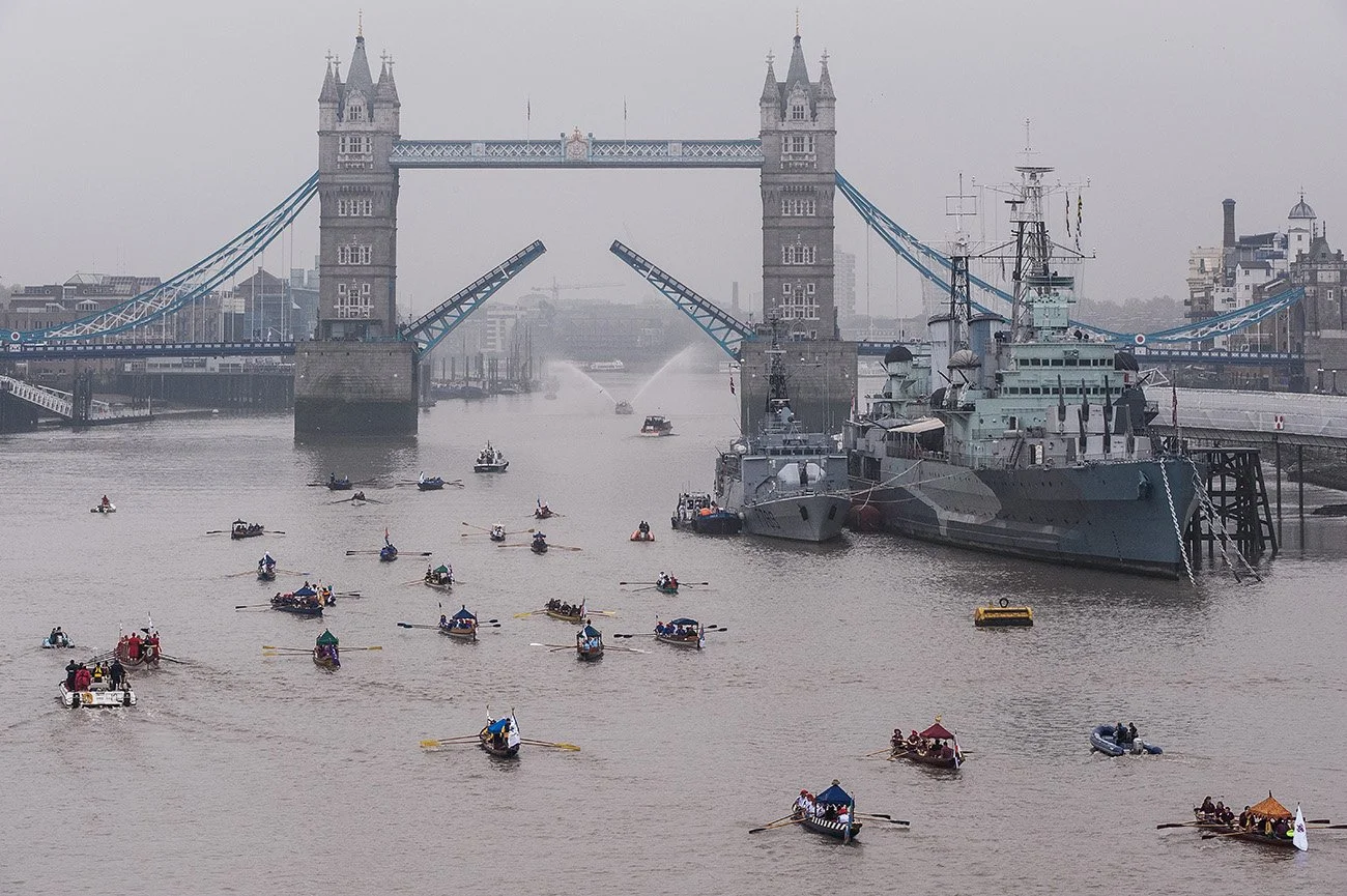 Tower Bridge is raised in salute to the new Lord Mayor on the barge Gloriania accompanied by barges of the livery companies