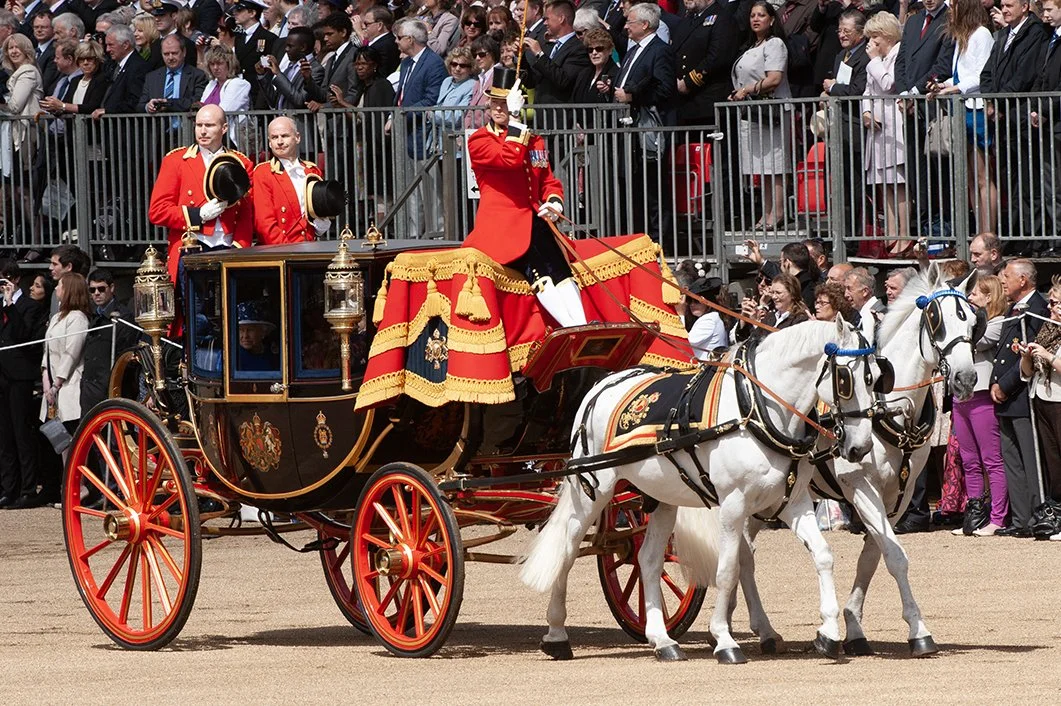 The coachman and grooms salute as they pass the Colour 