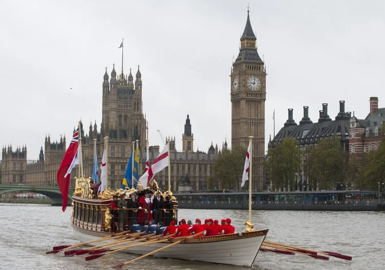 Early on the morning the Lord Mayor's Shoe Gloriana rows past the Palace of Westminster