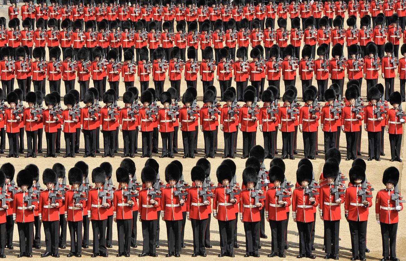 The Guardsmen on parade come to the halt having marched round the square in slow and quick time