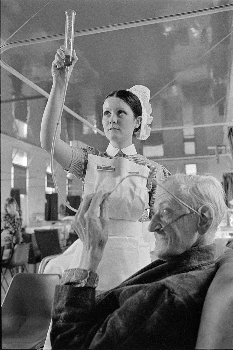 Ward nurse giving the patient a Guinness!