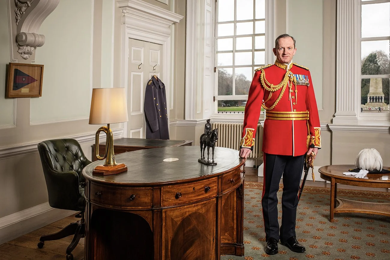 Major General Sir Christopher Ghika in his office overlooking Horse Guards. The desk was the Duke of Wellington's original desk and the model is of H.M the Queen riding her horse Burmese.