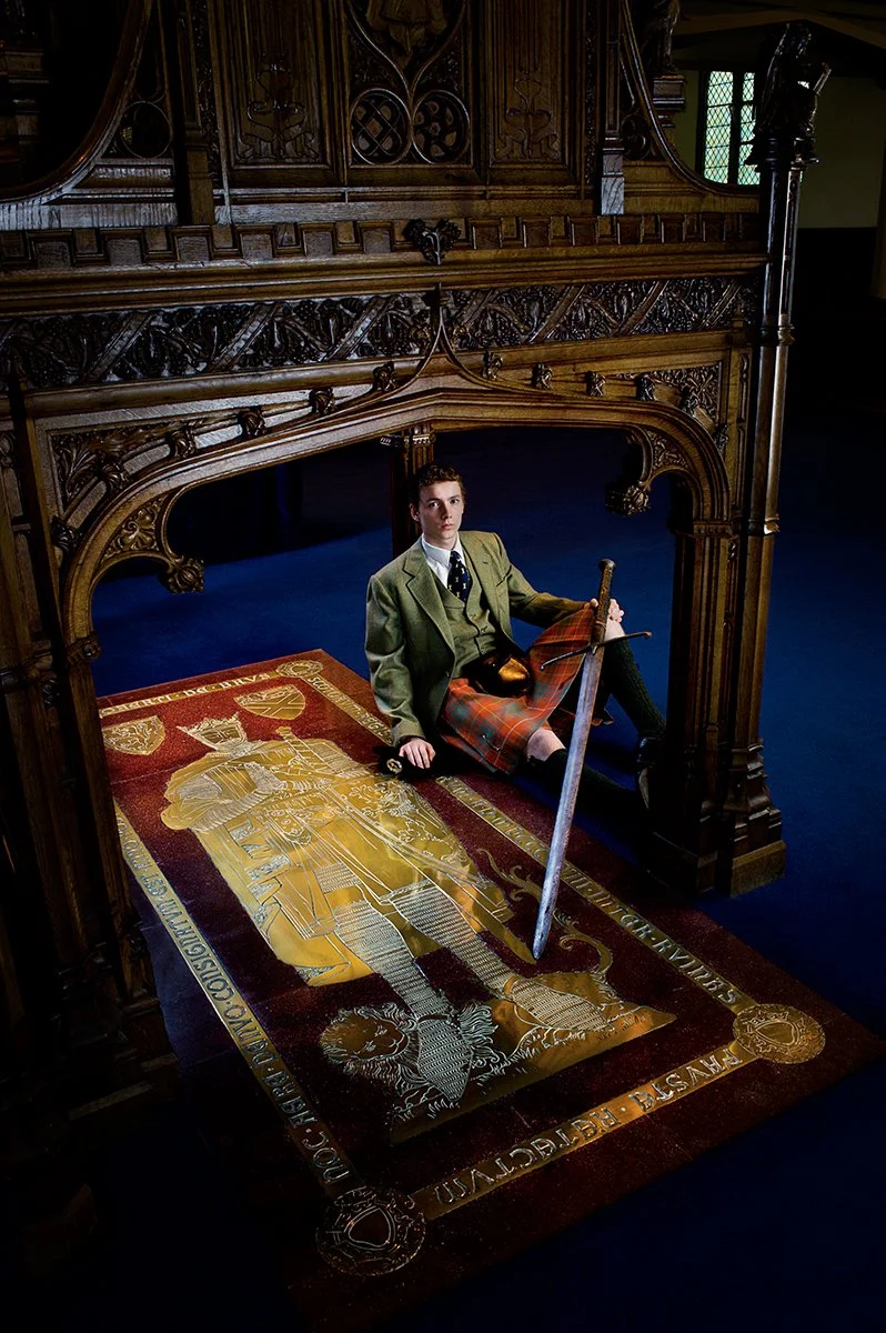The Master of Bruce sitting aside Robert the Bruce's tomb in Dunfernlaine Abbey. He is holding the Bruce's claymore