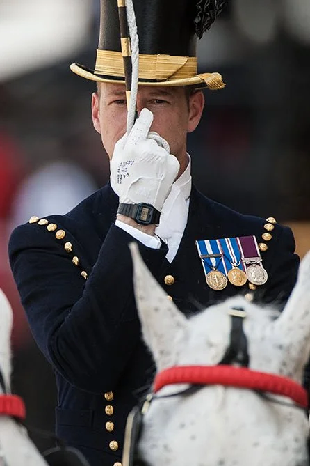 The Colonel's Review. The Head Coachman salutes the dias. Timings have been written on his gloves