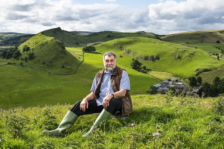Phillip Holland, poet and farmer, in the Peak District. Behind him is the setting for one of poems
