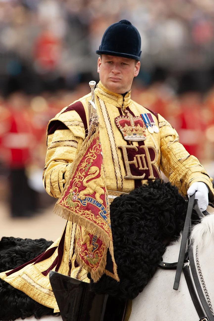 One of the State Trumpeters salutes Her Majesty as the mounted band leave the square