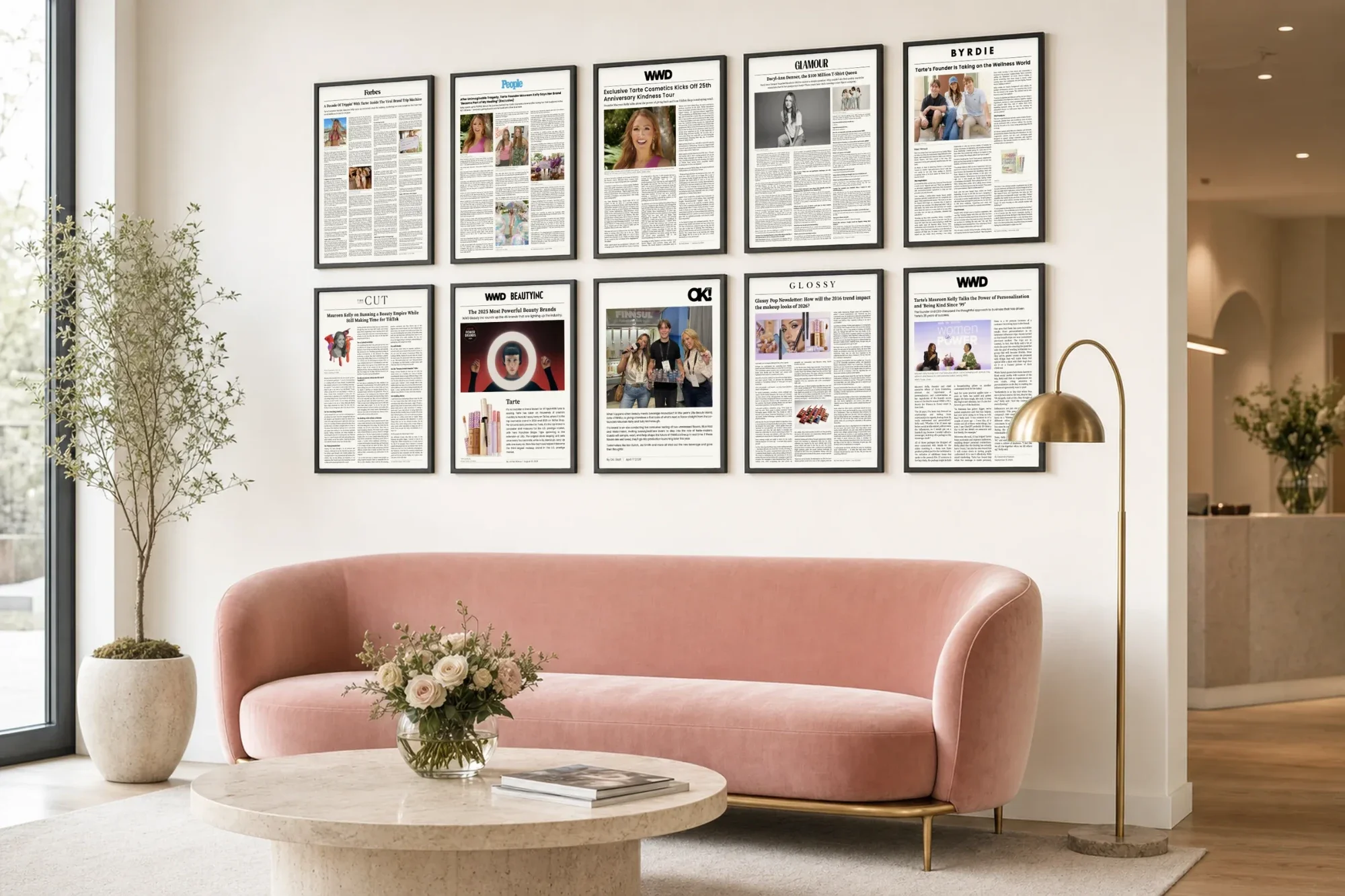 A press wall of ten matching framed articles above a sofa in a lobby