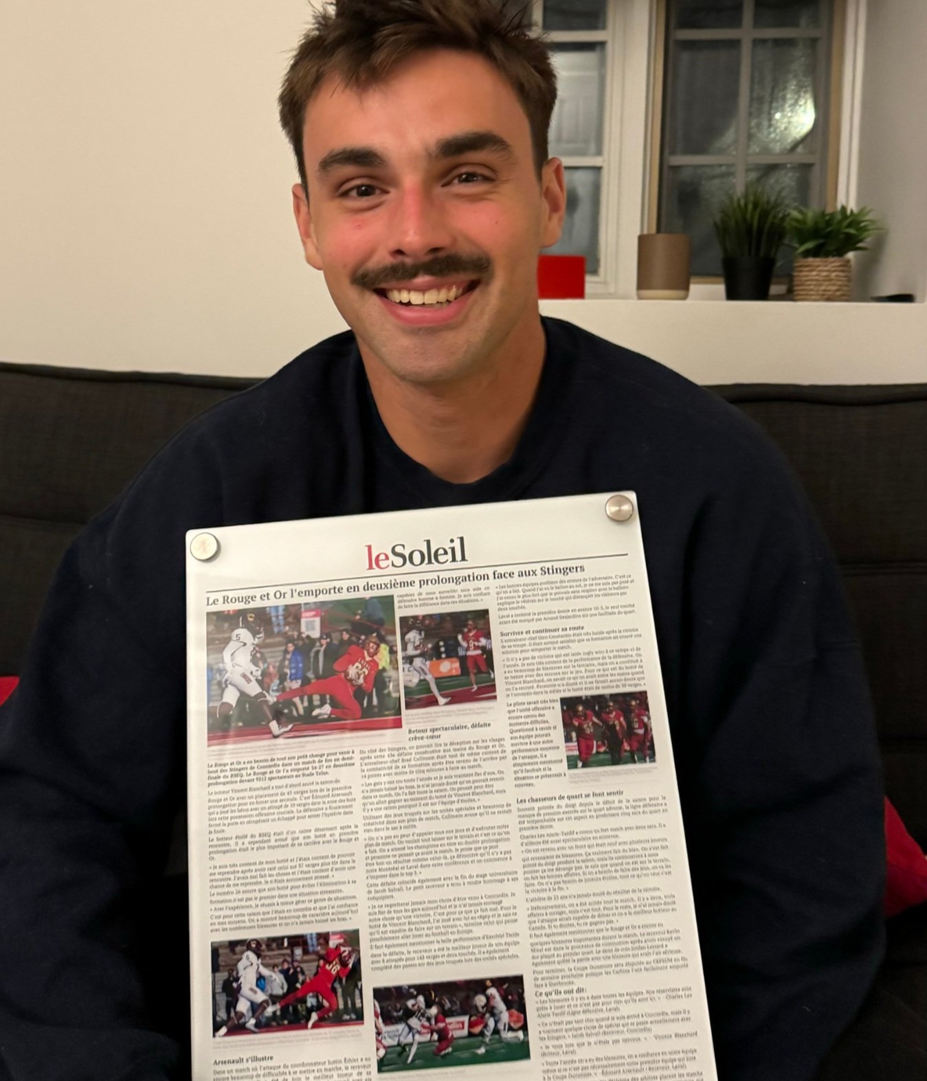 customer holding a custom acrylic plaque of a newspaper article
