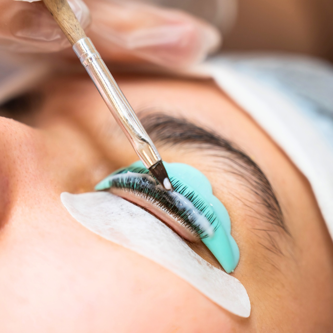 Professional lash lift and tint process at Bare Michigan in Rockford. A close-up showing natural lashes being curled using a specialized lash rod and applicator for a long- lasting, lifted look.