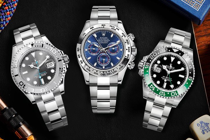 Three luxury watches with metal bracelets and detailed dials displayed on a dark surface.