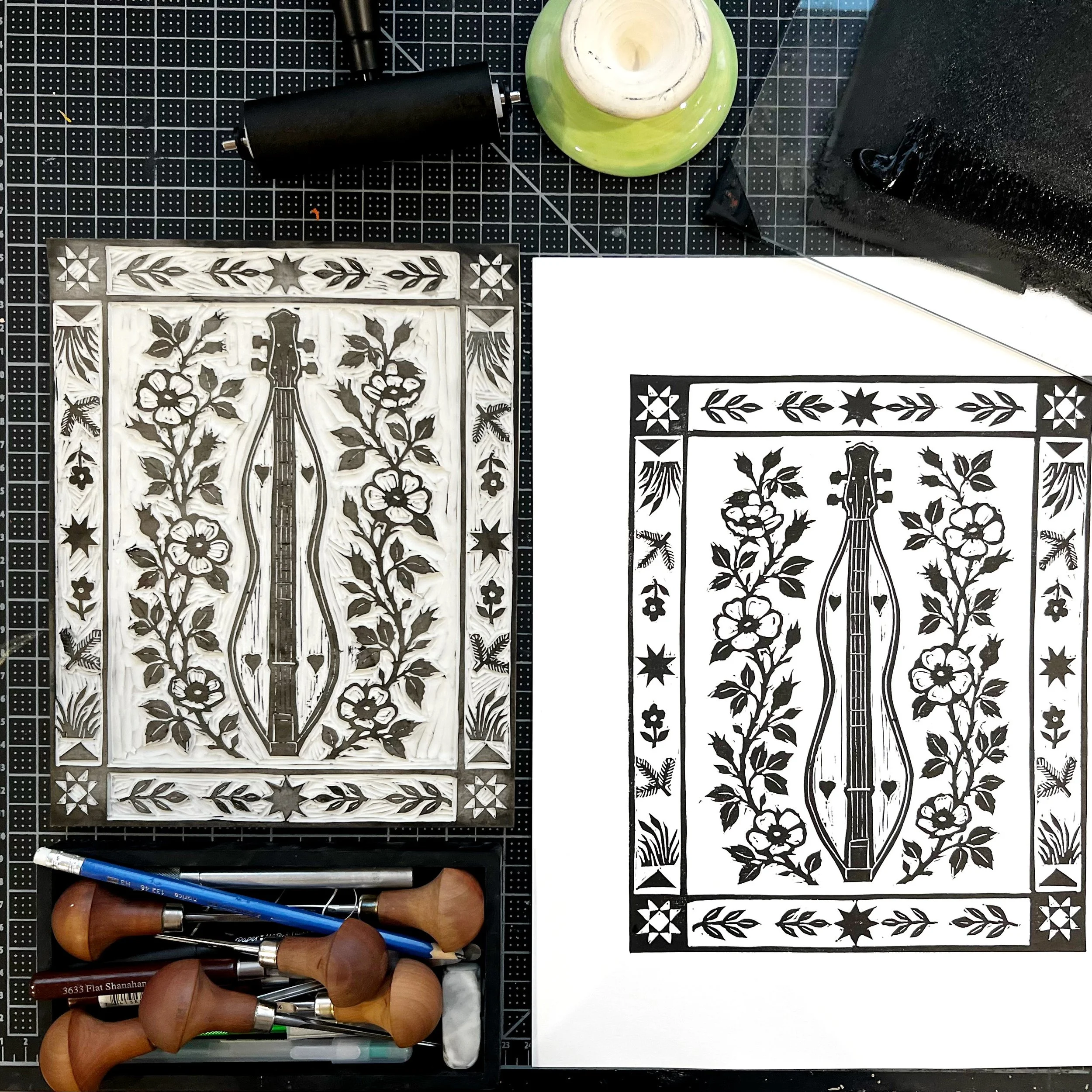 Carved linoleum block beside the finished black and cream botanical relief print