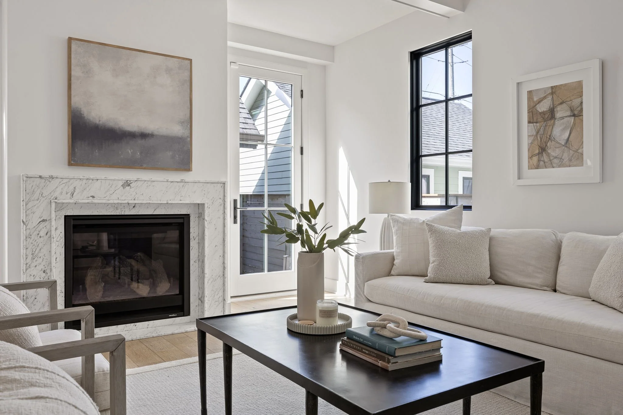 Carissa Hawkins, Indianapolis real estate agent with Home is a Feeling, light-filled living room with marble fireplace in downtown indianapolis
