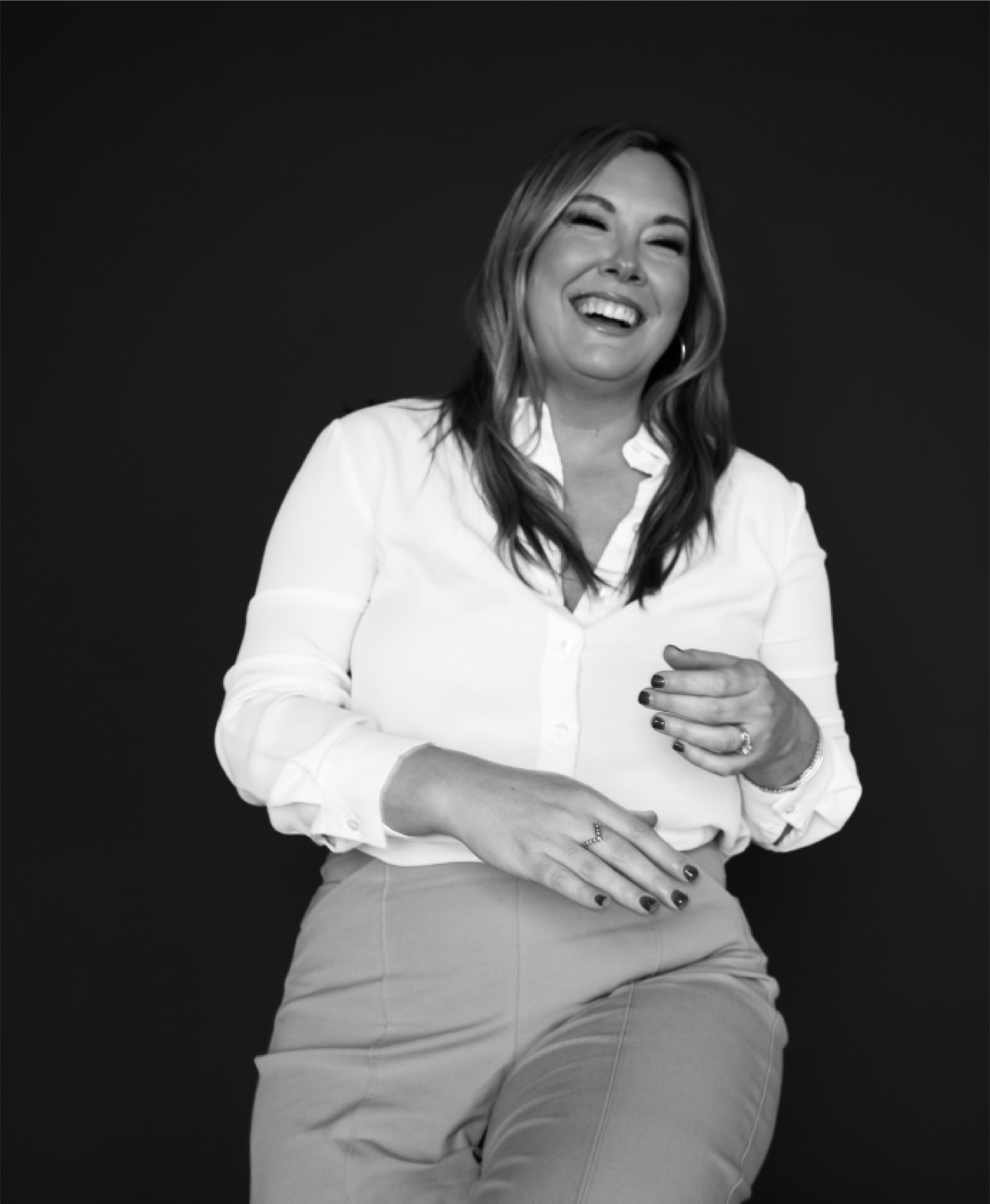 Carissa Hawkins, Indianapolis real estate agent with Home is a Feeling, smiling in a relaxed black-and-white portrait