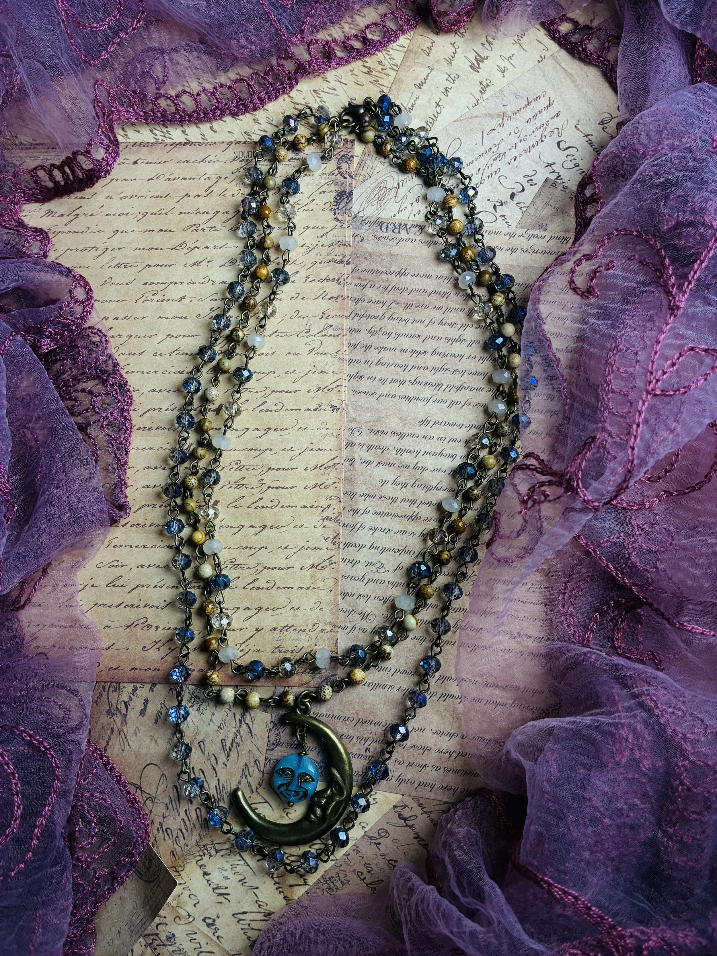 Celestial Moon layered blue beaded necklace with a sculptural crescent moon pendant.