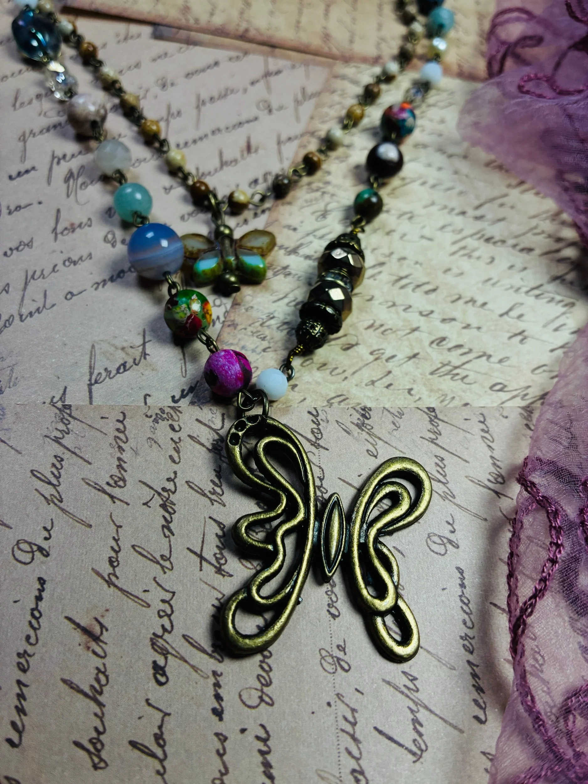 Full view of the two connected Mariposa necklace layers and butterfly details.