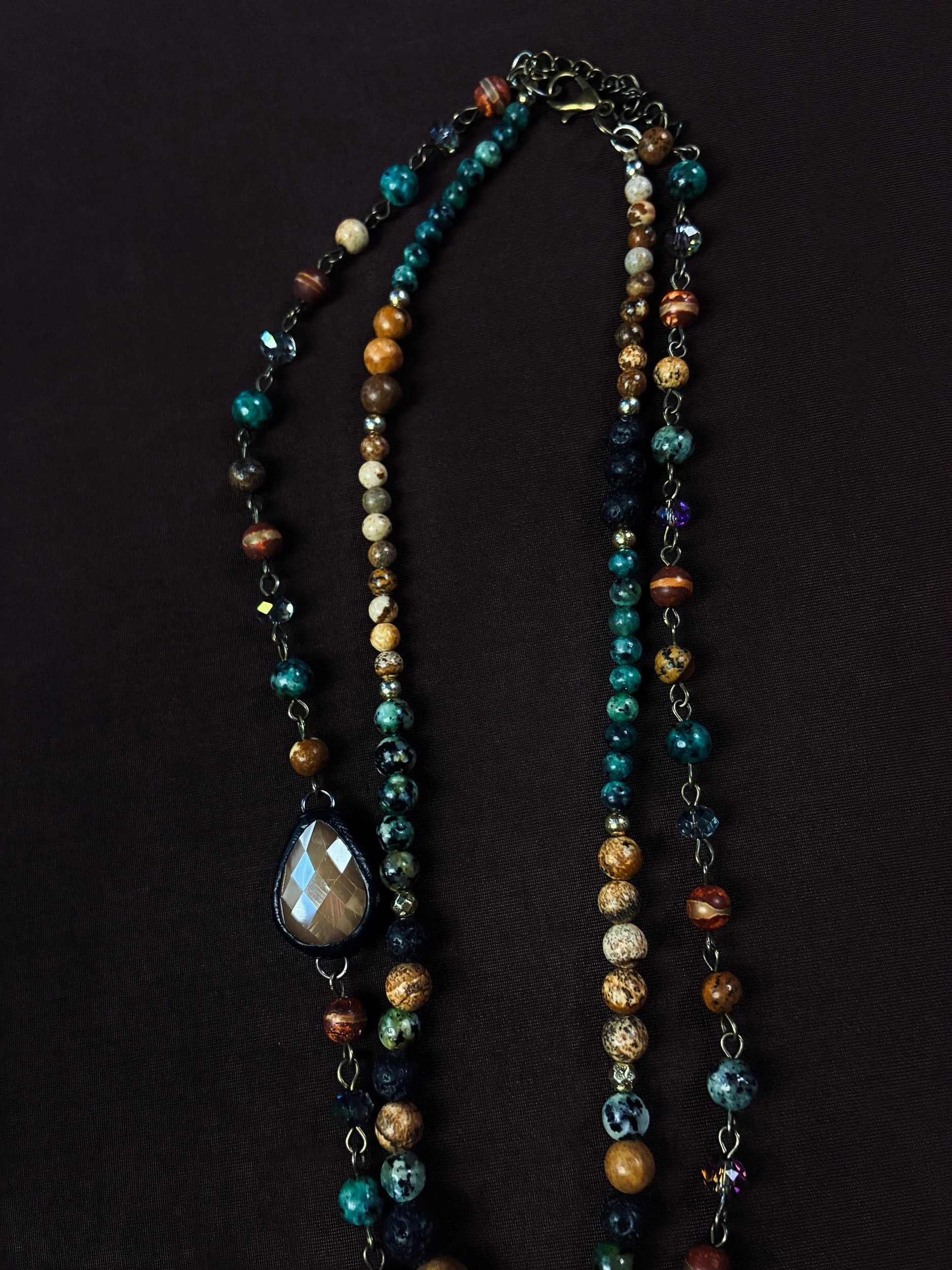 Full view of the three-layer Moss Cathedral necklace and faceted teardrop accent.