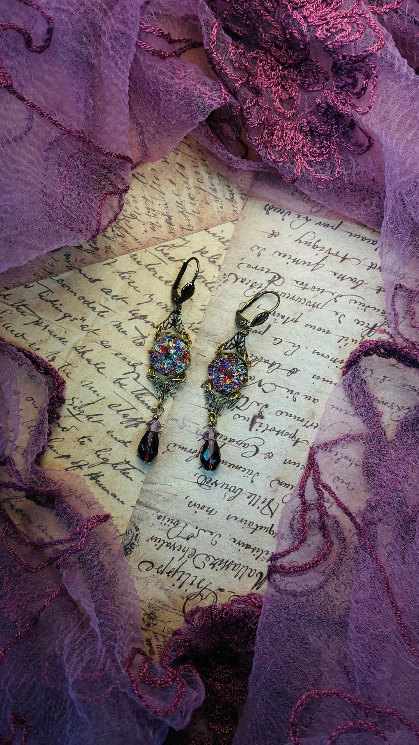 Close-up of the green glass drop and vintage-style metalwork on the Peridot earrings.