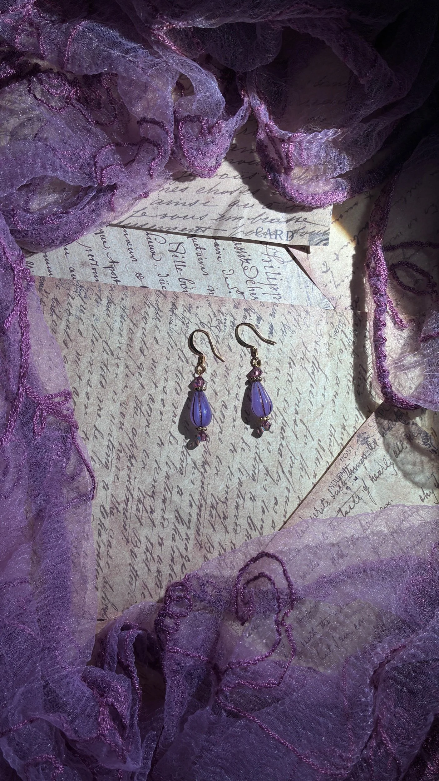 Elixir blue Czech glass drop earrings with faceted accents and gold-tone ear wires.