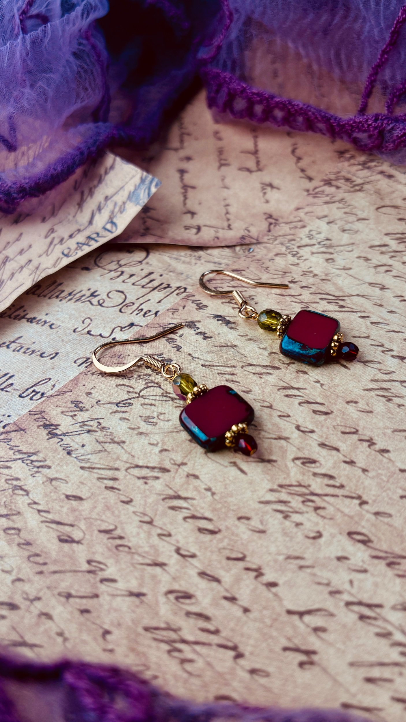 Close-up of the crimson and green details on the Pomegranate earrings.