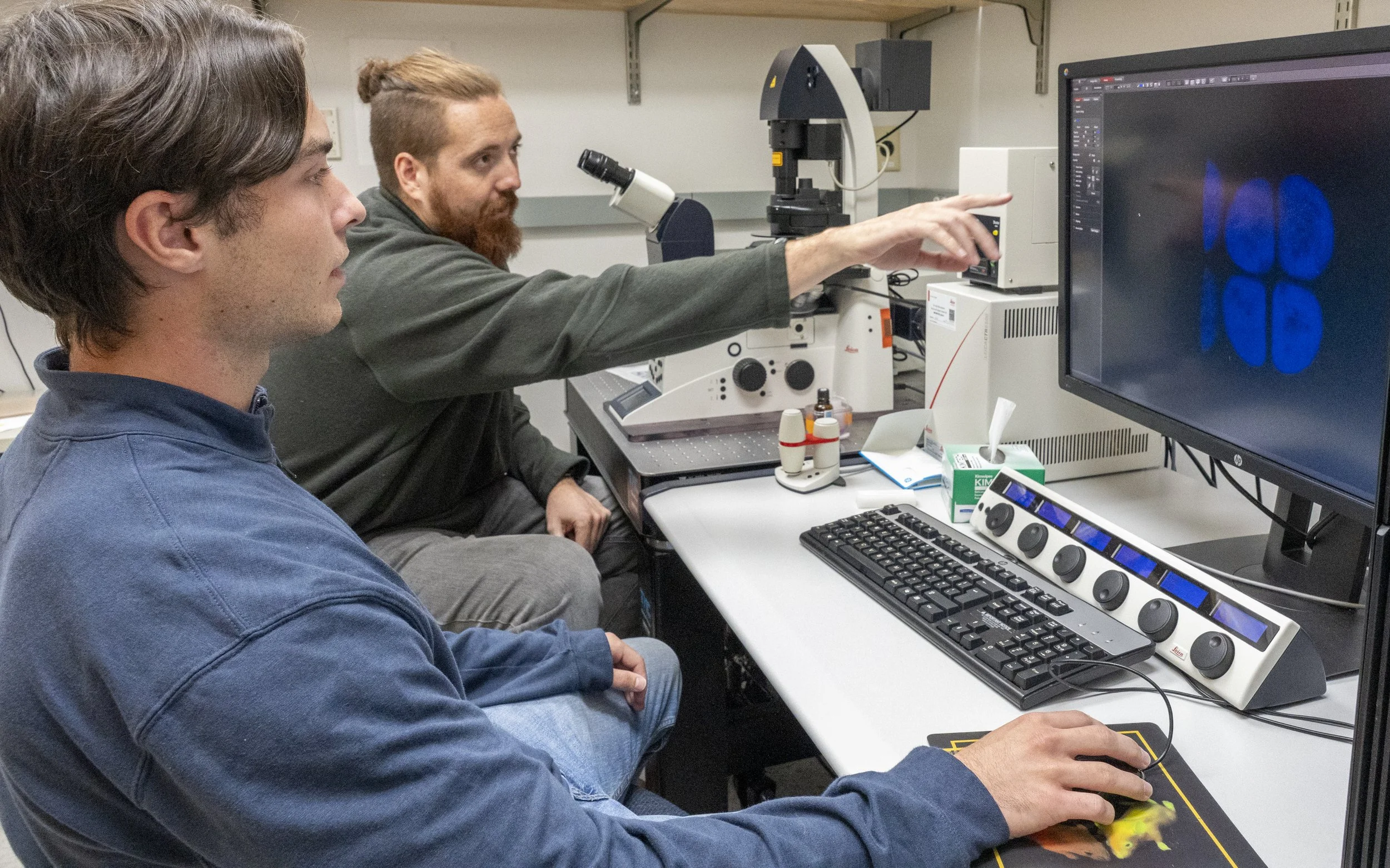 Chris B. and Kyle working on the fluorescence microscope
