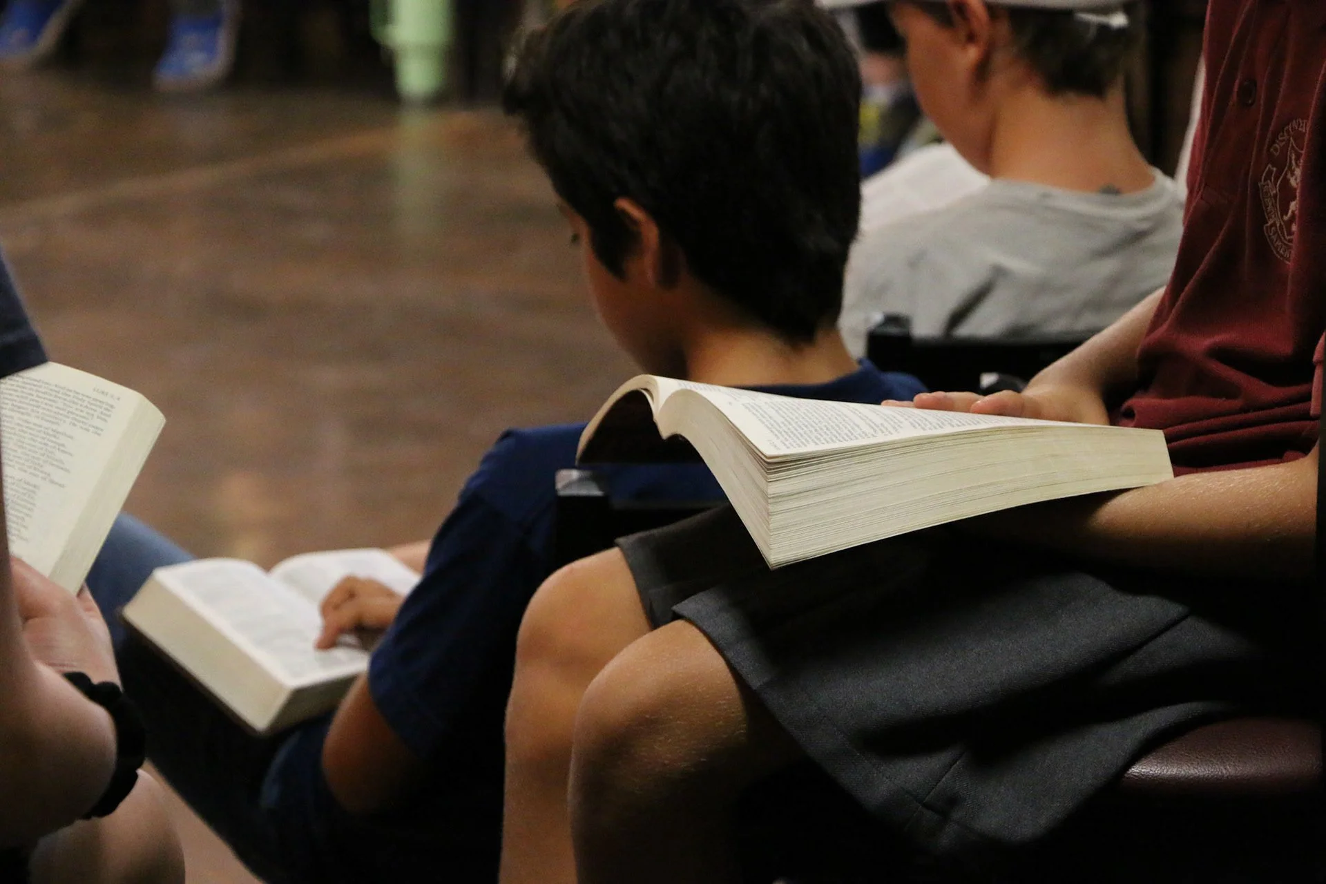 Open Bible with highlighted verses, resting on a wooden surface.