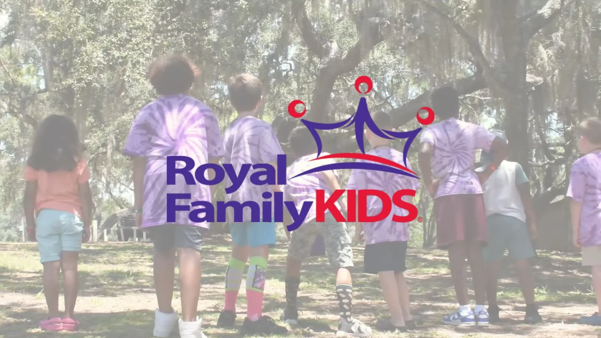 Royal Family Kids logo with purple and pink background, featuring three stylized figures with red circles for heads, suggesting children, and the text 'Royal Family KIDS' in bold letters.