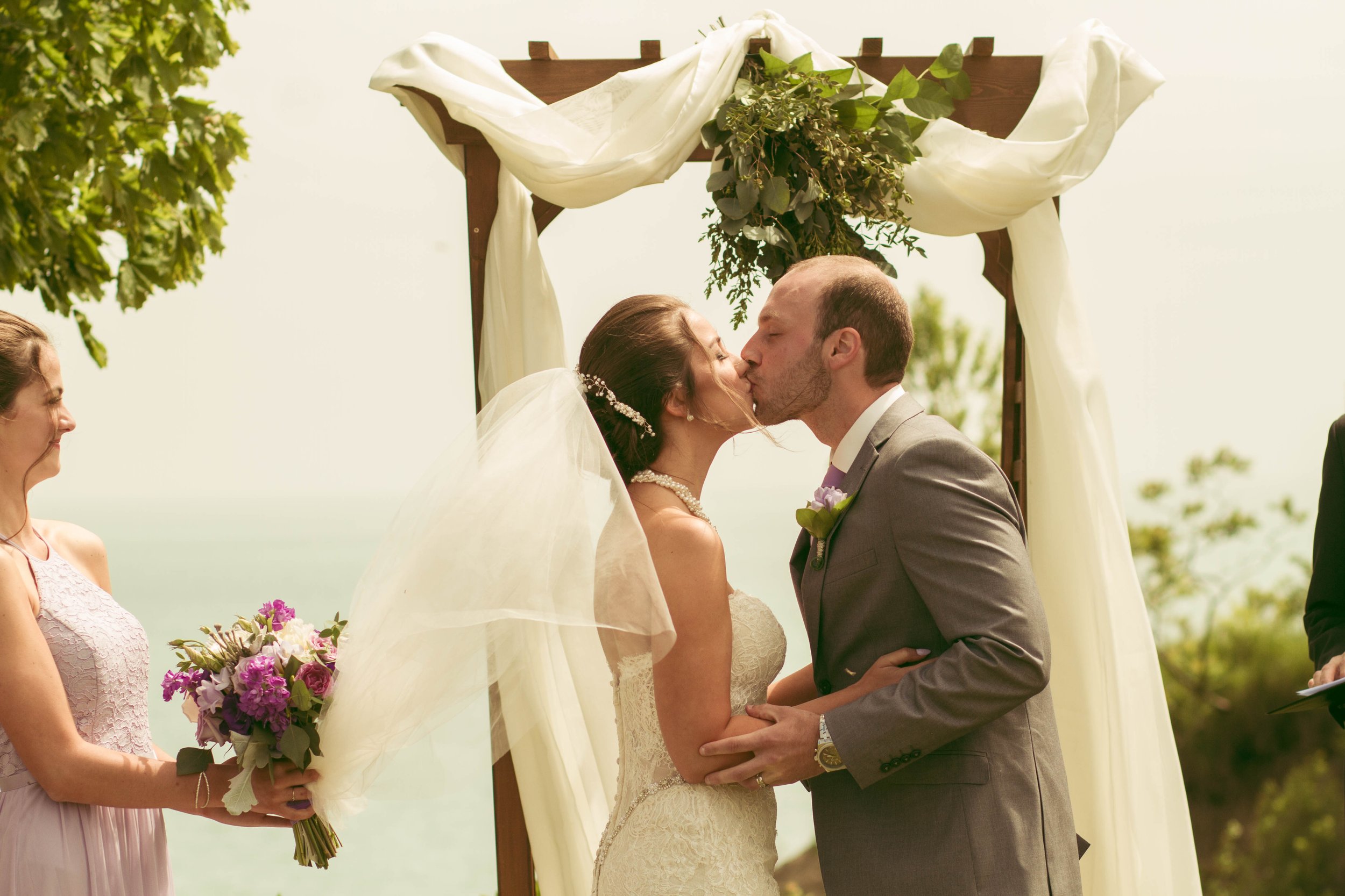 bride and groom at the altar of their beautiful wedding. First kiss