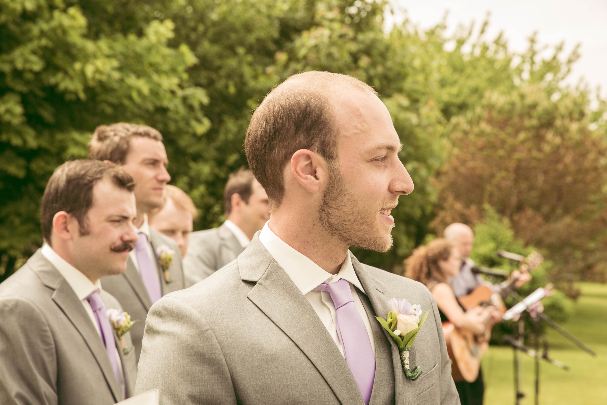 Beautiful outdoor wedding ceremony groom waiting for his bride
