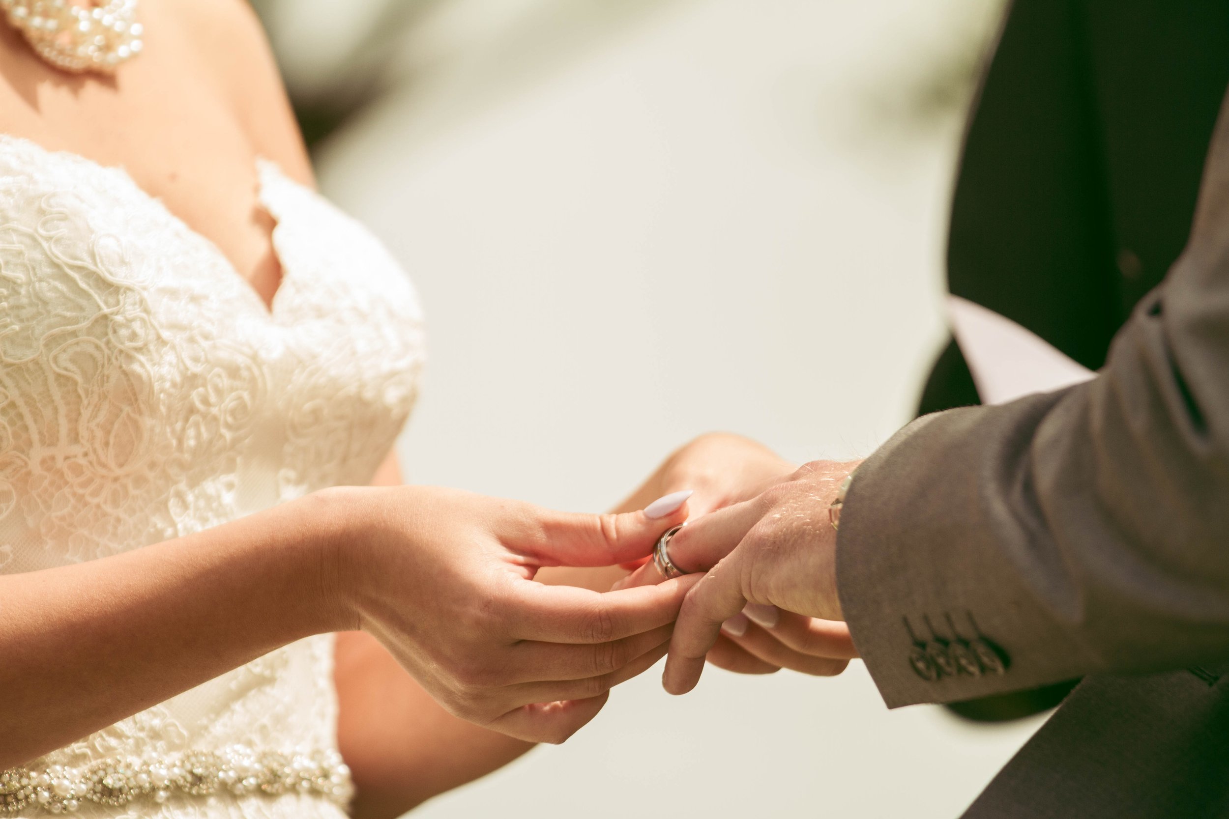 bride and groom at the altar of their beautiful wedding exchanging the rings