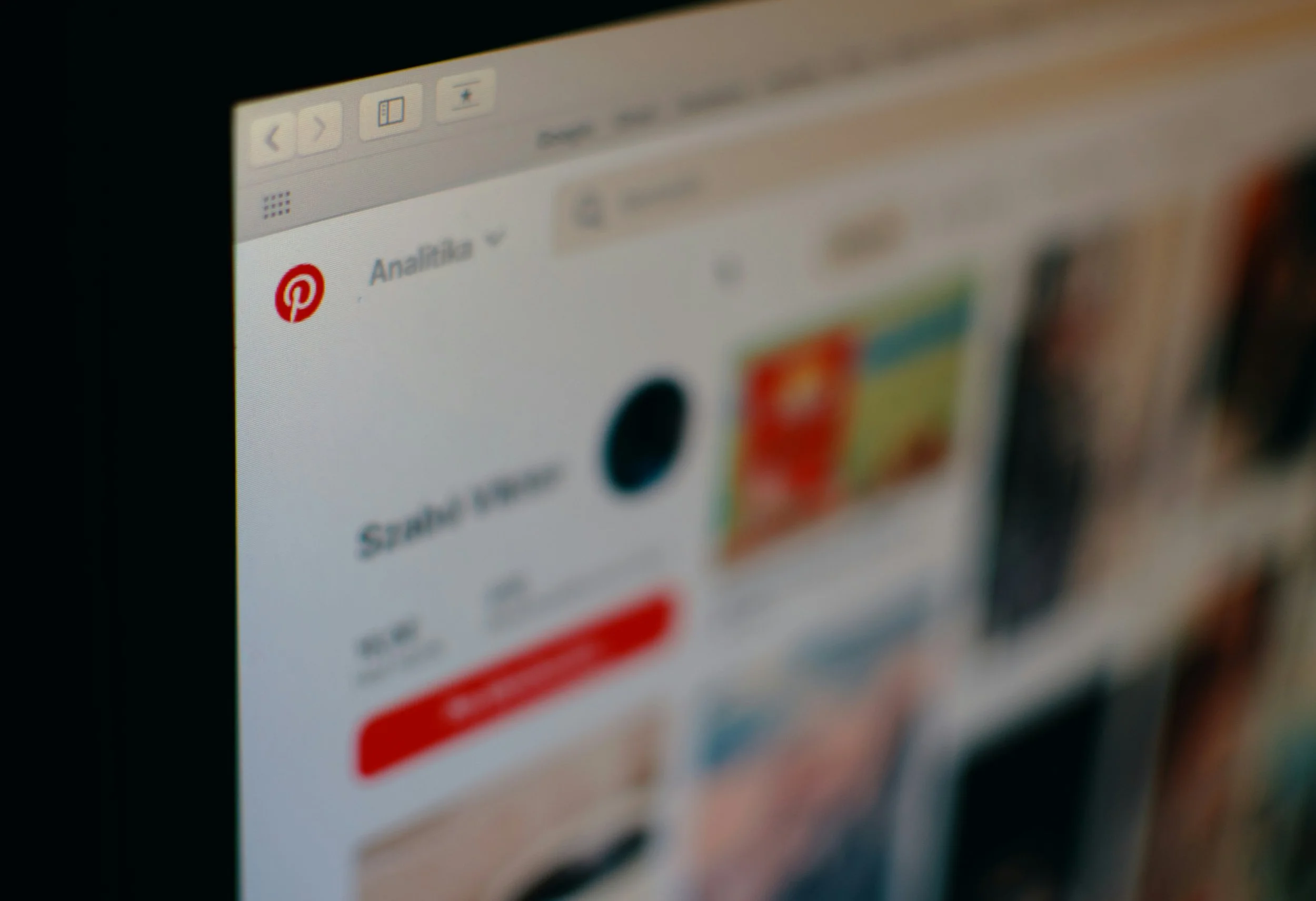 Slightly blurry laptop close up with the Pinterest logo in the left side and pinterest pins on the right