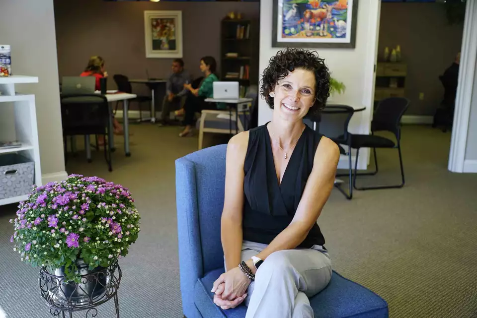 Christy Alexander sitting in WorkSmart's member lounge.png