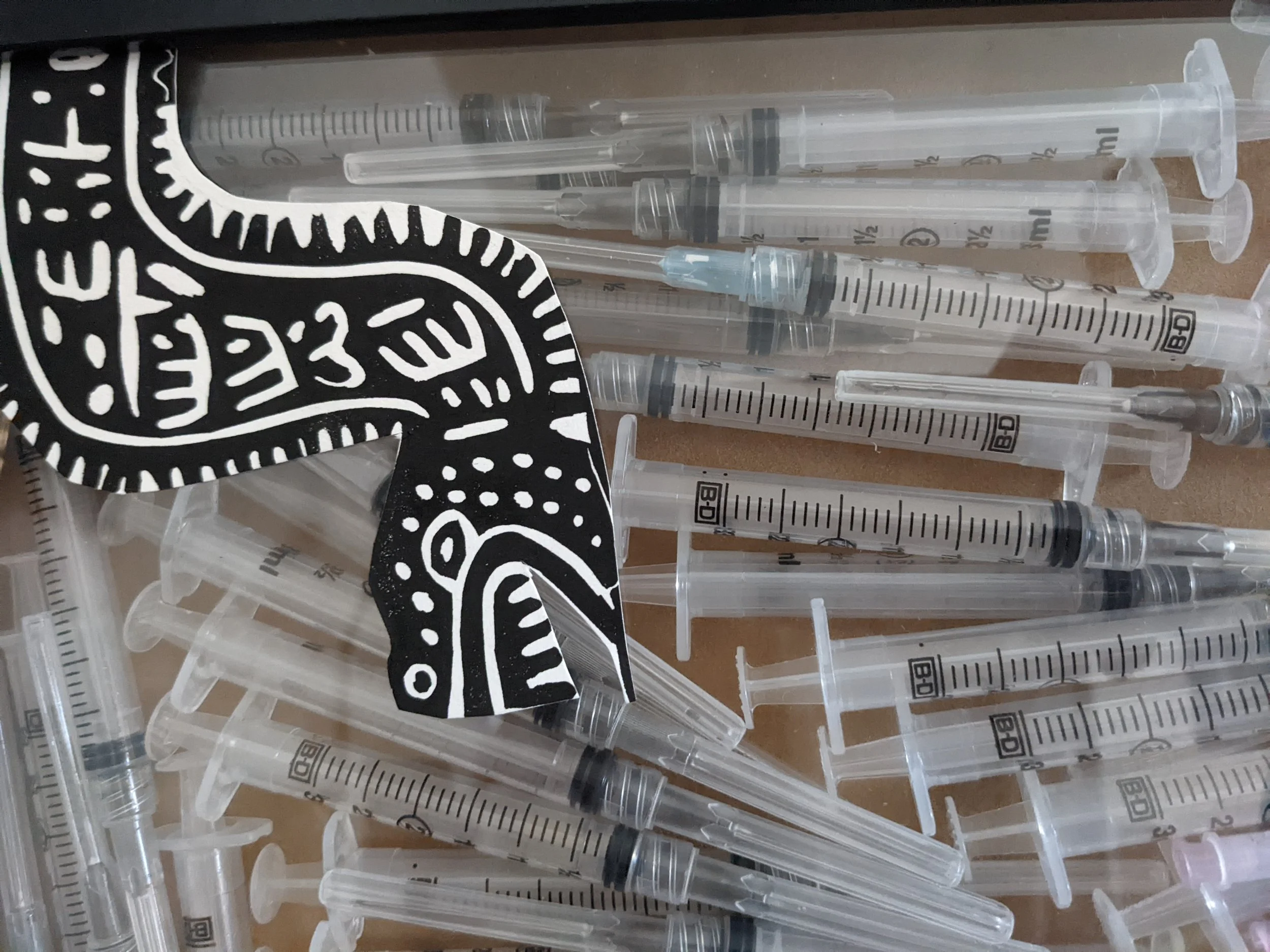 close up shadow box containing my IVF treatment syringes