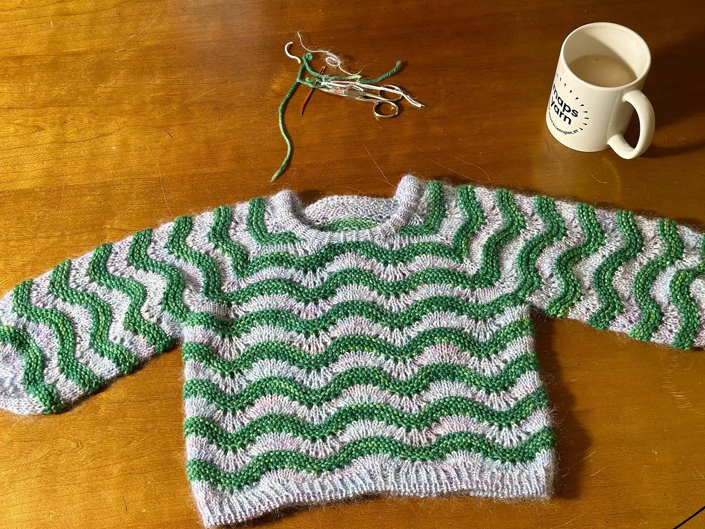 off to CO this lil qt goes! inspired by 2 of my niece&rsquo;s favorite things: mermaids and snakes (!), a little #jeansweaterjunior by @sari_n_ made with Maps Yarn SW DK in Moist Green &amp; Maps Yarn Luxe Sock in 6am This Morning 🧜&zwj;♀️🐍